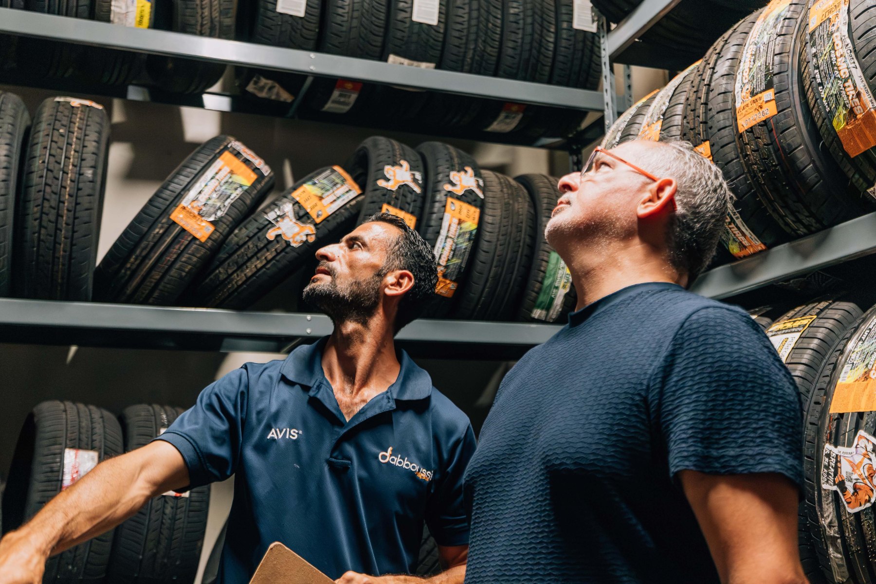 Two of the team checking tyre stock on the racks in the Dabboussi Motors parts store.